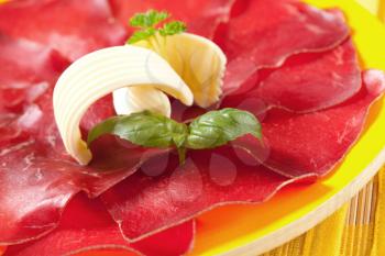 Thin slices of dry cured meat and butter