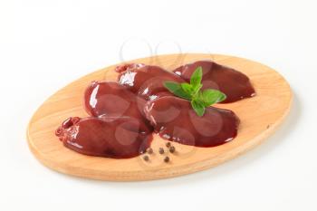 Raw chicken liver on cutting board