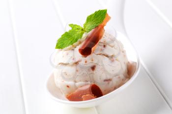 Scoop of stracciatella ice cream on porcelain spoon