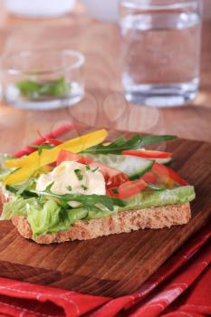 Vegetarian open faced sandwich on a cutting board