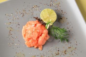 Gravlax garnished with lime, dill and seasoning
