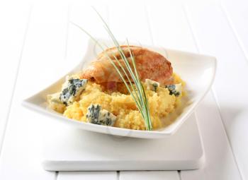 Roast chicken breast served with couscous and blue cheese