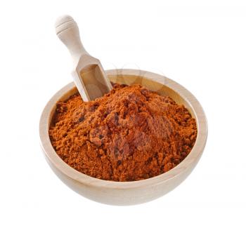 Ground red pepper in a wooden bowl