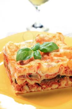 Portion of lasagna on a yellow plate