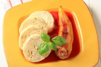 Hungarian pepper stuffed with minced meat served with tomato sauce and dumplings