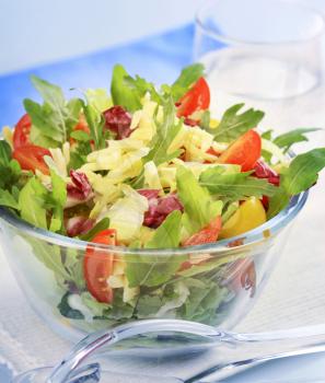 Bowl of spring salad sprinkled with grated cheese
