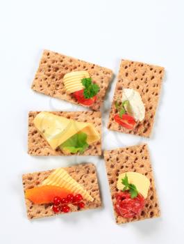 Whole grain crisp bread slices with various toppings