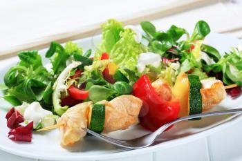 Chicken skewer with mixed salad greens