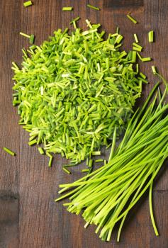 Fresh chives on wooden background