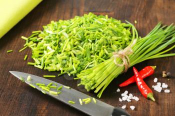 Fresh chives on chopping board