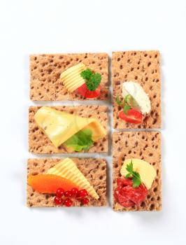 Whole grain crisp bread slices with various toppings