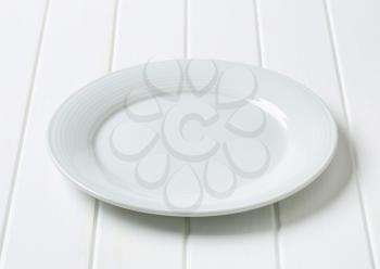 Single white clean porcelain plate