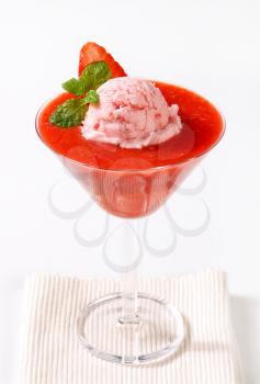 Ice cream with strawberry puree in cocktail glass