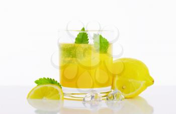 Glass of fresh lemon juice drink with ice