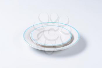 Dinner plate and side plate with blue colored edges