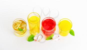 fresh fruit juices and iced drinks on white background
