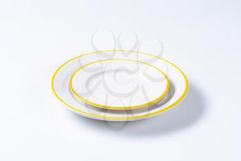 Dinner plate and side plate with yellow colored edges