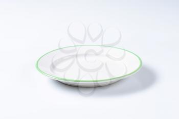 Rimmed dinner plate with green colored edge
