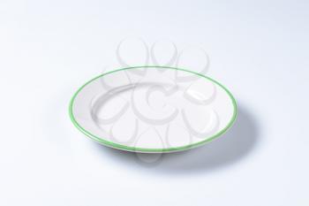 Rimmed dinner plate with green colored edge
