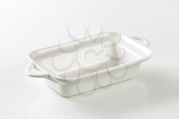 Deep rectangular white ceramic dish with handles