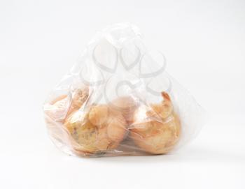 raw onions in transparent plastic bag