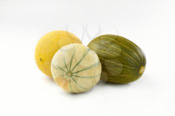 three fresh melons on white background
