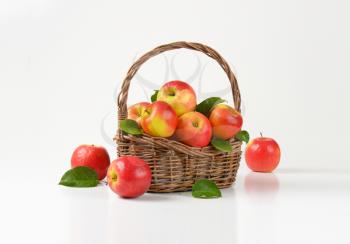 fresh red apples in a wicker basket