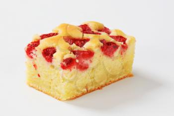 a piece of homemade raspberry cake on white background