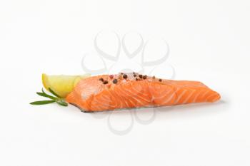 raw salmon fillet with salt, spice, rosemary and lemon