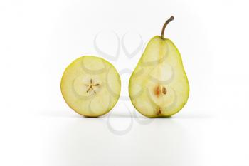 two halves of ripe pear on white background