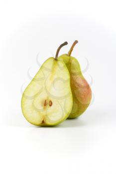 one and half ripe pears on white background