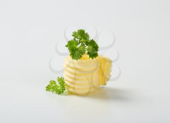 butter curl with parsley on white background