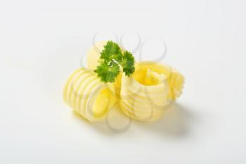butter curls with parsley on white background