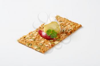 pumpkin seed cracker with white rind cheese