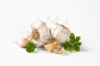 Fresh garlic bulbs and cloves on white background