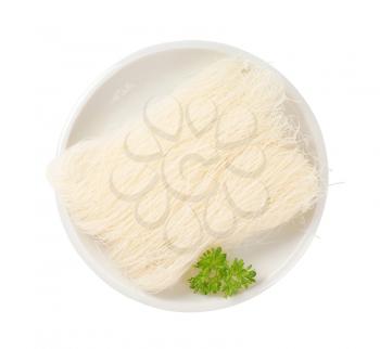bundle of dried rice noodles on plate