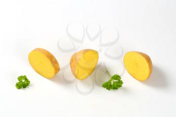 sliced raw potato on white background