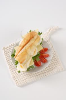 sandwich with eggs and cheese on white plate