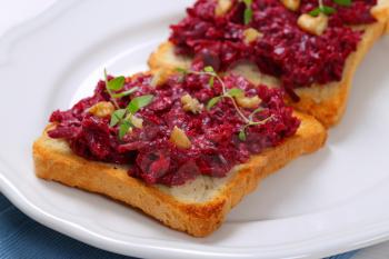 toast with beetroot spread on white plate - close up