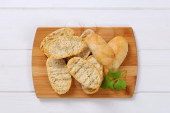 pile of crispy rusks on wooden cutting board