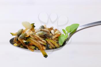 Spoon of zucchini salad with seeds