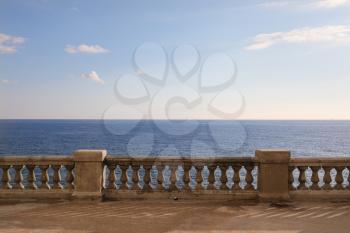 View from a terrace with old stone balustrade overlooking the sea