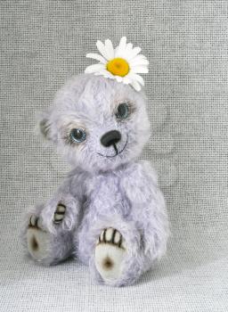 Handmade, the sewed toy: lilac teddy-bear with a flower on a head