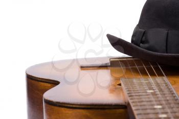 isolated guitar and hat on white
