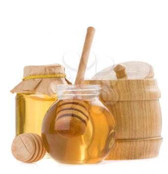 glass pot of honey and stick isolated on white background