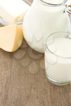 milk products and cheese at wooden background