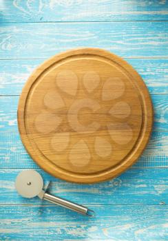 pizza cutting board at wooden table