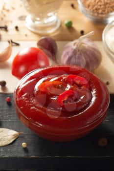 tomato sauce in bowl on wooden background
