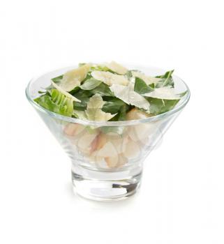 caesar salad in glass bowl isolated on white background