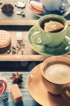 cup of coffee, cacao and tea on wooden background
